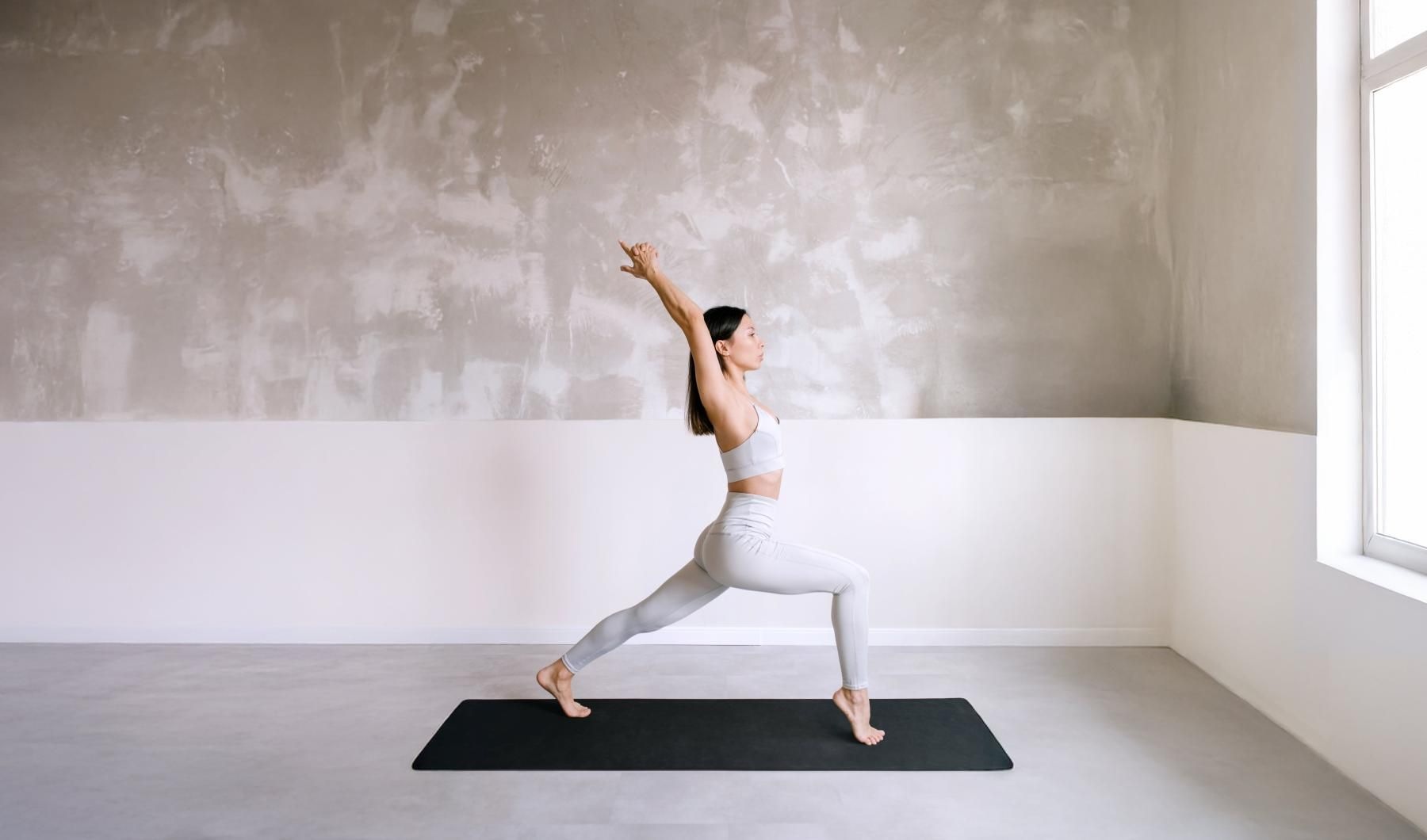 Settle into comfort at J. Rivelle a person doing yoga in a room